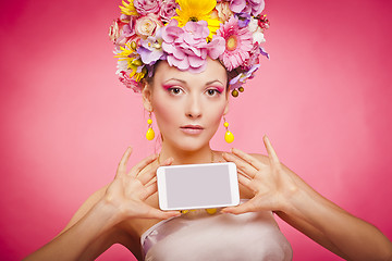 Image showing Spring flowers girl is holding smartphone in hands