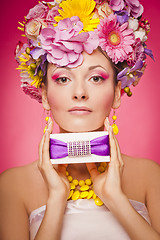 Image showing Woman with gift box and flowers hair