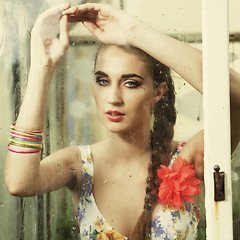 Image showing girl behind wet window