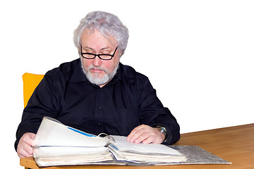 Image showing Senior is checking some papers