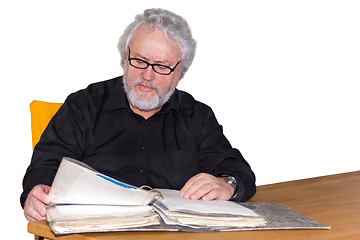 Image showing Senior is checking some papers