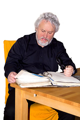 Image showing Senior is checking some papers