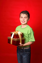 Image showing Boy carrying gifts