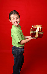 Image showing Smiling child carrying gifts