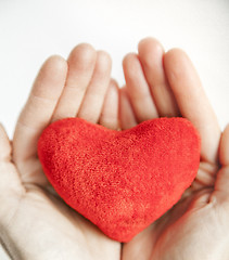 Image showing love concept. holding a red heart in hands.