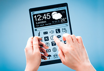 Image showing Tablet with transparent screen in human hands.