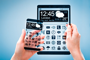 Image showing Smartphone and tablet with transparent screen in human hands.