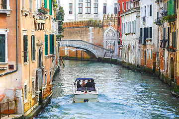 Image showing Boat with tourists sailing in water canal