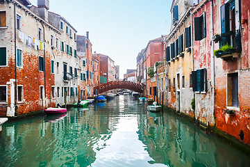 Image showing Boats moored next to buildings in water canal