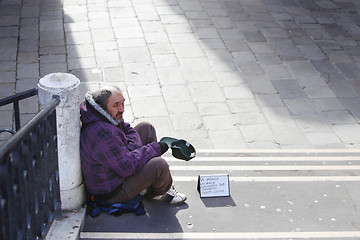 Image showing Beggar sitting on stairs in Venice