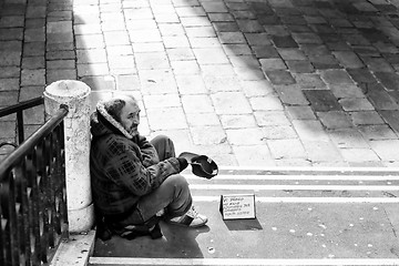 Image showing Beggar sitting on stairs in Venice bw