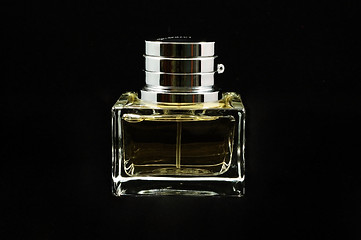 Image showing Bottle of perfume over black background