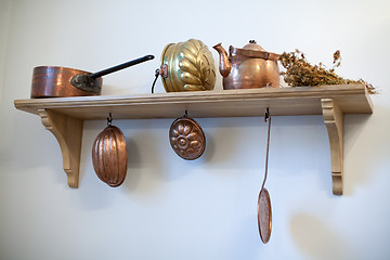 Image showing kitchen shelf with old copper utensils