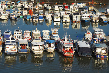 Image showing Various parked boats in row