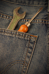 Image showing wrench and a screwdriver in his pocket jeans workers