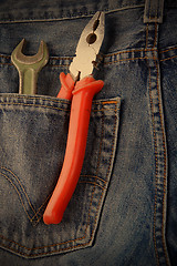 Image showing wrench and pliers in jeans pocket