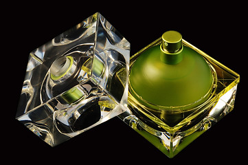 Image showing Opened perfume bottle over black