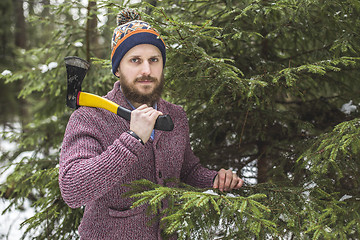 Image showing Lumberjack near the christmas tree in forest