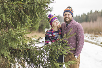 Image showing Young couple hugging in winter forest