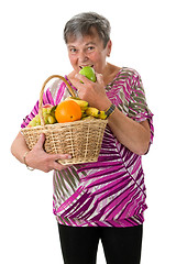 Image showing Senior woman biting into an apple