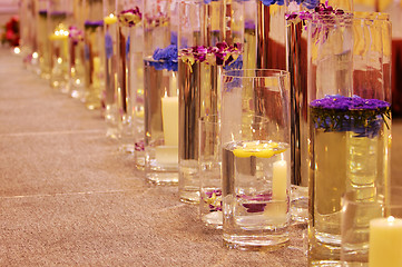 Image showing Row of different vases with flowers and candles