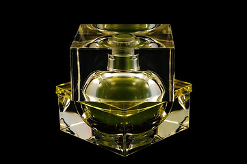 Image showing Bottle of perfume over black background
