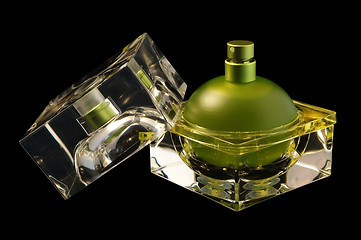 Image showing Opened perfume bottle over black