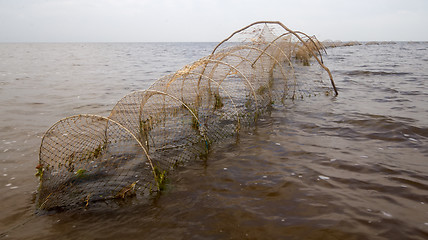 Image showing fishing net  a fish-trap on lake