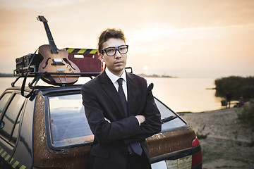 Image showing Musician old cheap car and guitar