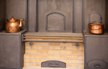 Image showing big stove with old copper utensils