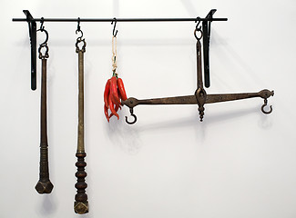 Image showing kitchen railing with old copper scales and utensils