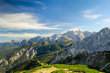 Image showing Alps sunlight high mountains peaks with green valley and blue sk