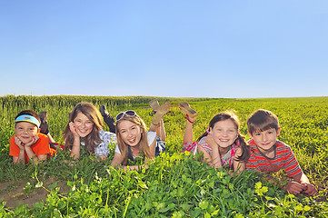Image showing happy kids laying in the field