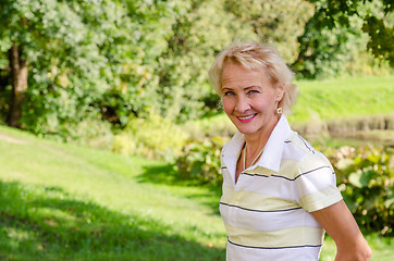 Image showing Portrait of a middle-aged woman in a park on a sunny day