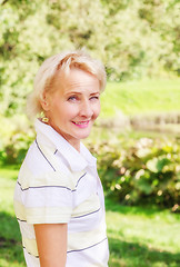 Image showing Portrait of a middle-aged woman in a park on a sunny day