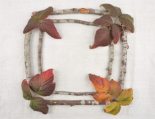 Image showing Wooden frame with bramble leaves