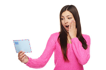 Image showing Surprised woman looking at envelope