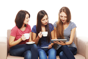 Image showing Three girls friends using tablet