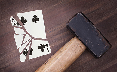 Image showing Hammer with a broken card, four of clubs