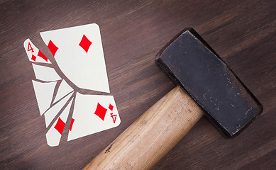 Image showing Hammer with a broken card, four of diamonds