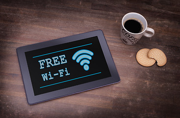 Image showing Tablet with Wi-Fi connection on a wooden desk
