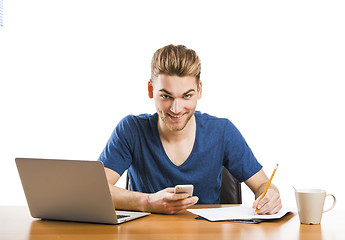 Image showing Young man sending text messages