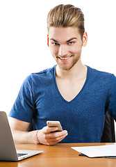 Image showing Young man sending text messages