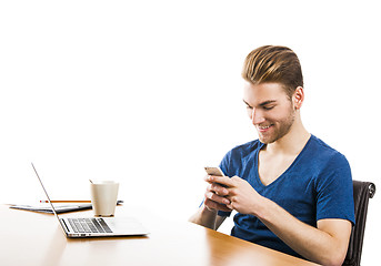Image showing Young man sending text messages