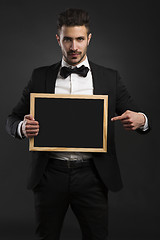 Image showing Young man holding a chalkboard
