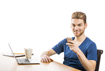 Image showing Young man sending text messages