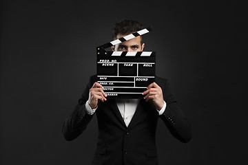 Image showing Business man holding a clapboard