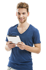 Image showing Young man working with a tablet