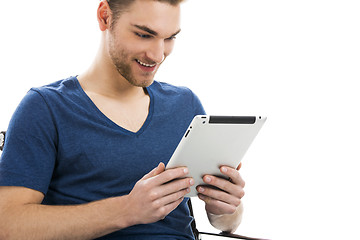 Image showing Young man working with a tablet