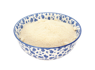 Image showing Golden caster sugar in a blue and white china bowl